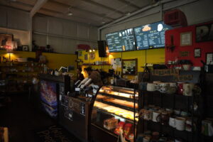 Vintage Paris counter with menu, baristas working and baked goods on display.