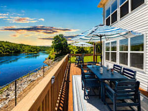 Affordable Branson Rentals with glassed sunroom and deck overlooking Lake Taneycomo at Fireside on the Lake.