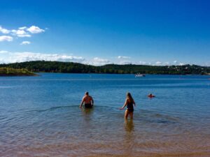 ): Families swimming at Moonshine Beach, among the best swimming holes Branson offers on Table Rock Lake