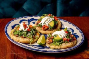Sopes with seasoned meat lettuce tomato and queso fresco at Delicias Factory Branson MO