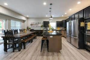 Open kitchen and dining area at Livin' The Dream with a long farmhouse table and island