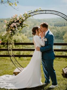 Outdoor Ozark wedding ceremony at a Branson destination venue with rustic barn and mountain views