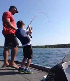 Fishing guide charter boat on Table Rock Lake Branson Missouri with clear Ozark mountain water views