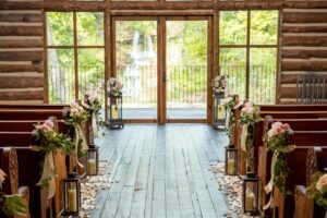 Outdoor Ozark wedding ceremony at a Branson destination venue with rustic barn and mountain views