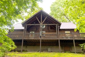 Back deck with propane grill at Eagle Nest Log Cabin, a Branson area vacation rental in Ridgedale