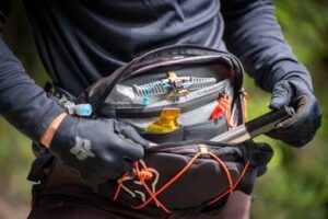 Rider prepping gear at an Ozark trailhead near Branson — helmet, hydration, and repair kit for the ride