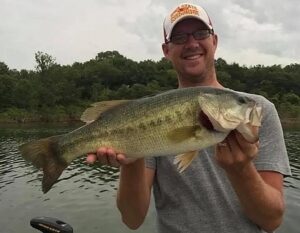 Angler holding largemouth bass caught on Table Rock Lake Branson Missouri during 2026 fishing season