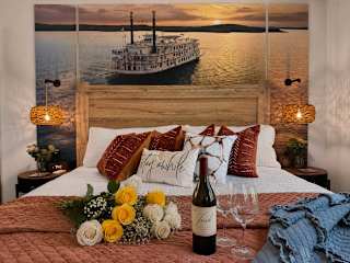 King bedroom at Celebrate Branson with a Branson showboat mural headboard wall