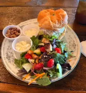 A plated lunch at Azalea's Garden Bistro in Branson West — chicken salad sandwich and soup