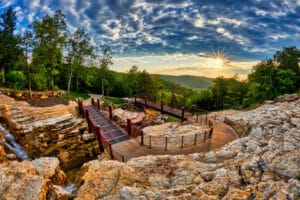 A cart on the Lost Canyon Cave and Nature Trail at Top of the Rock near Branson passing an Ozark waterfall