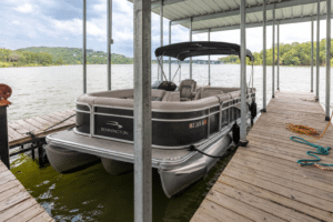 Boat tied up in a rentable boat slip at a Branson lake house dock