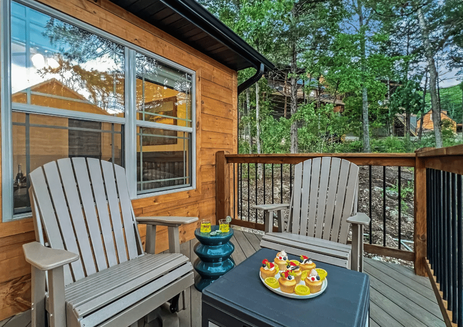 Wooded back deck with Adirondack chairs at a Branson-area fall getaway cabin in Hollister