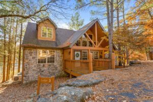 Exterior of Rivers Creek lodge in Branson West surrounded by trees and autumn foliage.