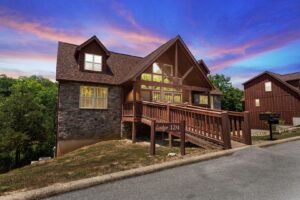 Exterior of Timeless Memories Lodge in Branson West with stone accents, wood siding, and a front deck.