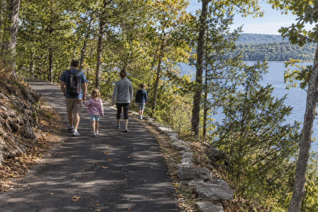 Family hiking near Branson pauses at a scenic Ozark overlook above the lake.