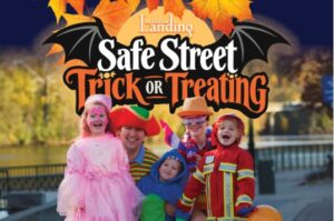 Kids in Halloween costumes under the Safe Street Trick-or-Treating logo at Branson Landing, a Branson Halloween tradition
