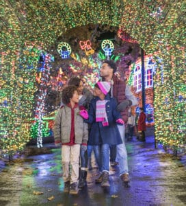Family walking through the tunnel of lights at Silver Dollar City.