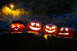 Rows of glowing jack-o'-lanterns lighting a night walking path during Branson Halloween events