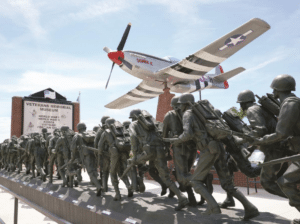 Veterans Memorial Museum in Branson in November at sunset with its bronze soldier procession and fighter-plane sculpture